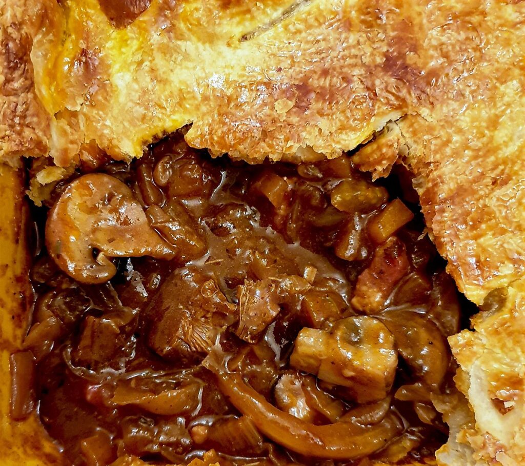 Close up of the inside of the pie showing the thick gravy.