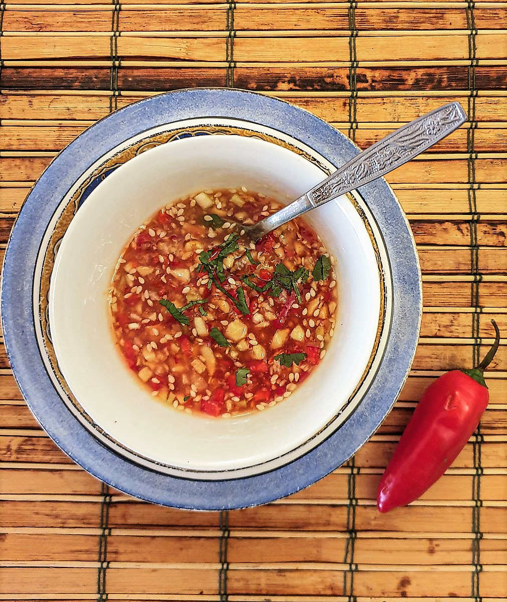 A dish of cucumber and peanut sweet chilli dipping sauce.