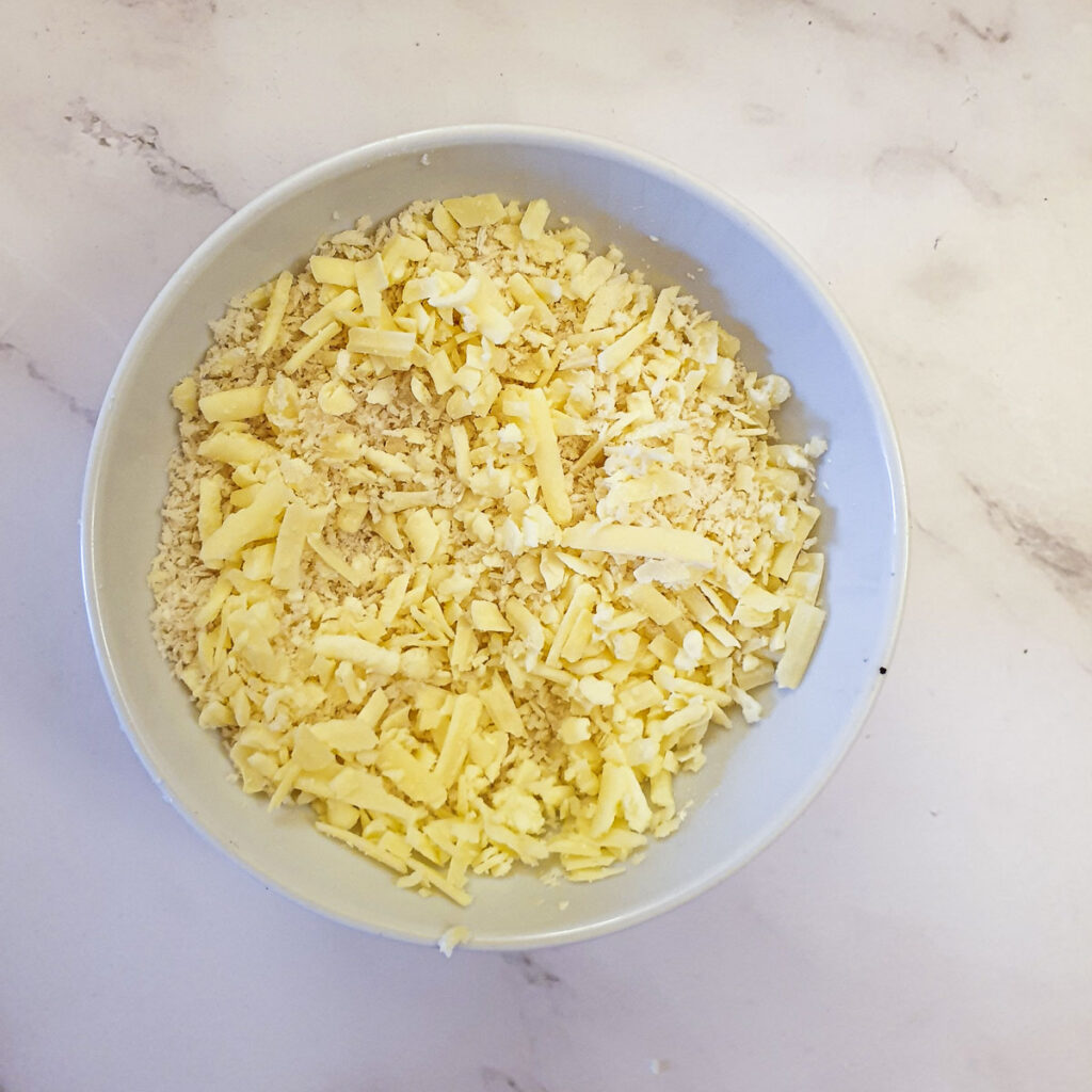 Grated cheese and panko breadcrumbs in a small bowl.