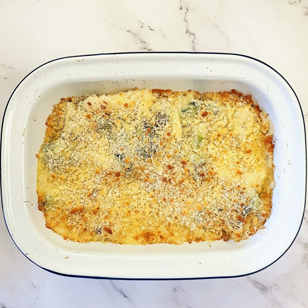 A dish of baked cauliflower and broccoli cheese after being browned in the oven.
