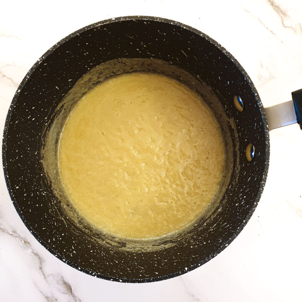 Melted butter mixed with flour in a saucepan.