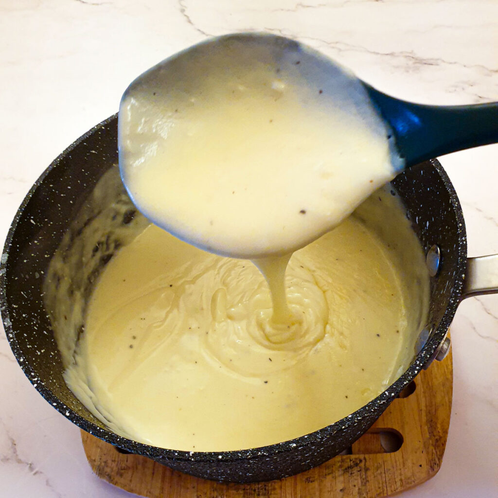 The sauce being poured from a spoon.