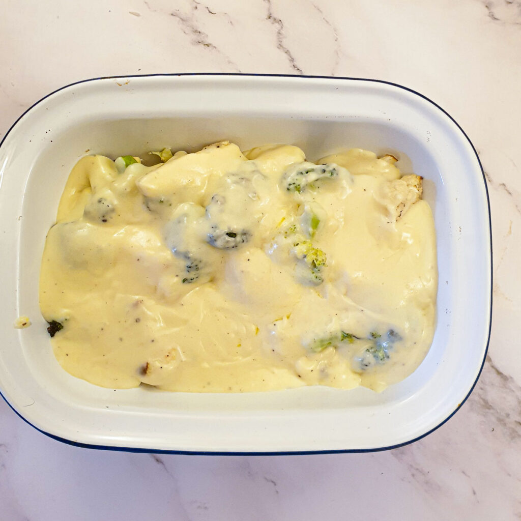 Cauliflower and broccoli covered in cheese sauce.