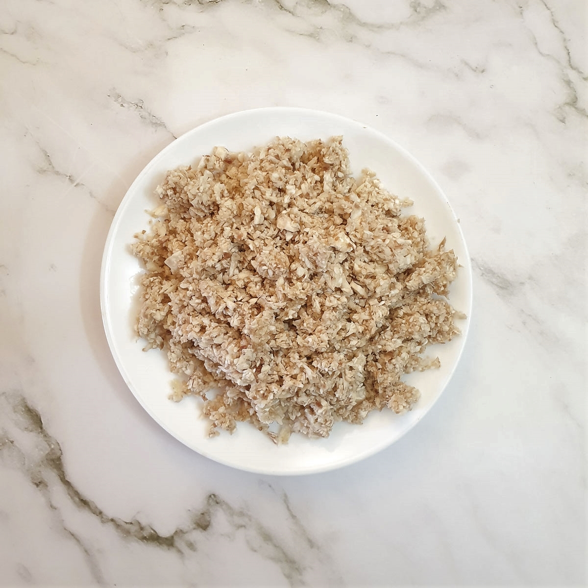 Finely chopped mushrooms on a plate.