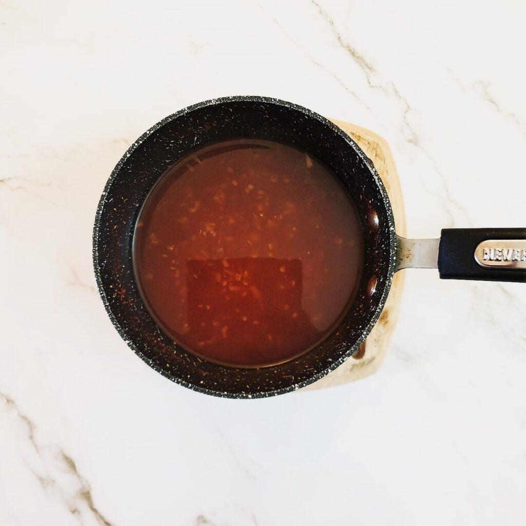 A saucepan of Durky sauce ready to be poured over the chicken wings.