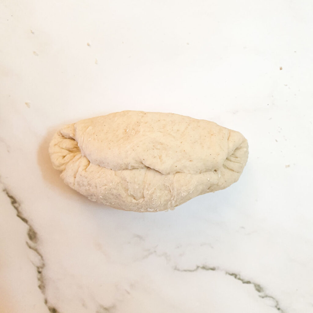 The dough rolled into a short fat sausage shape.