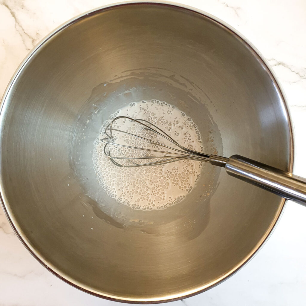 Yeast and water being mixed in a mixing bowl.