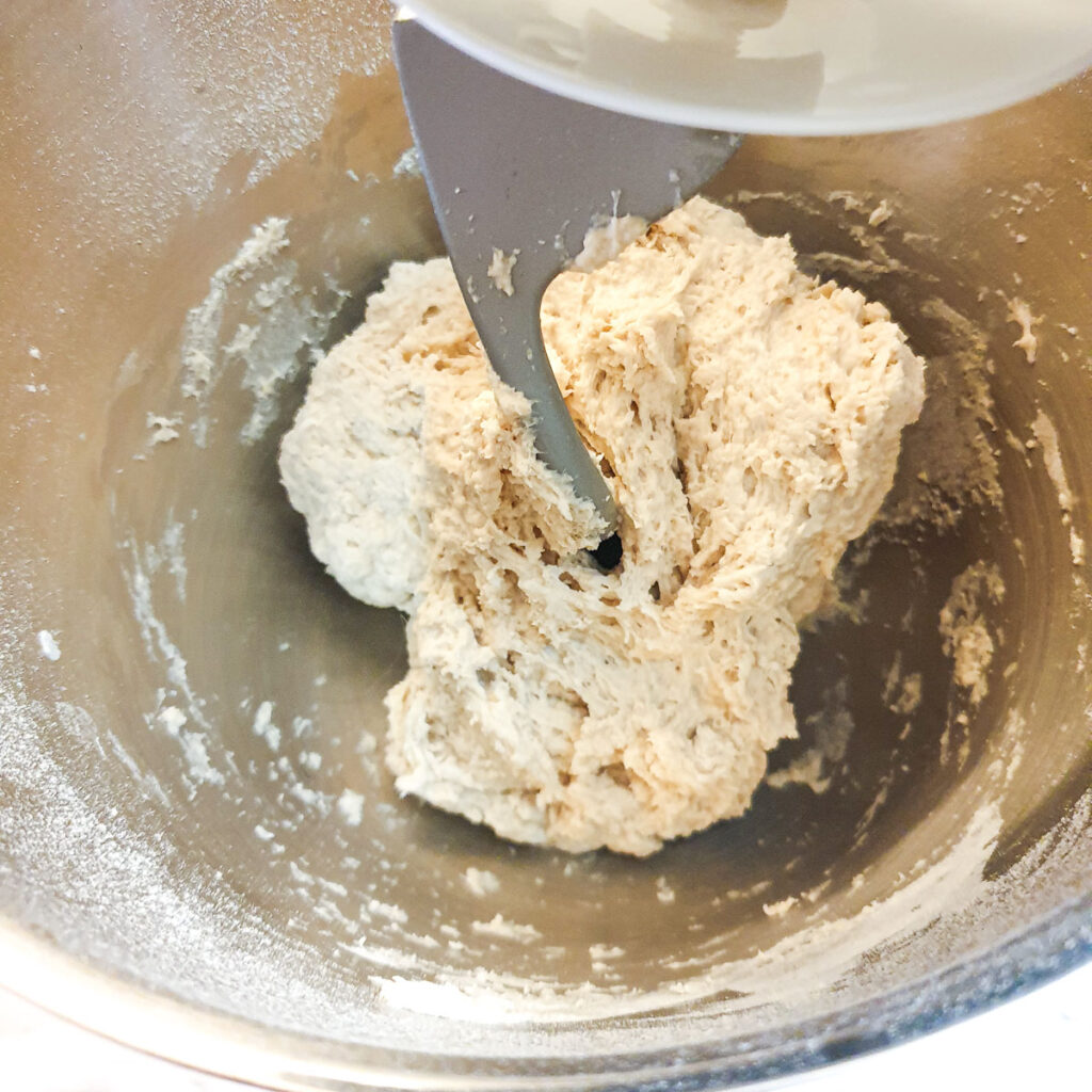 The dough being mixed in a stand mixer.