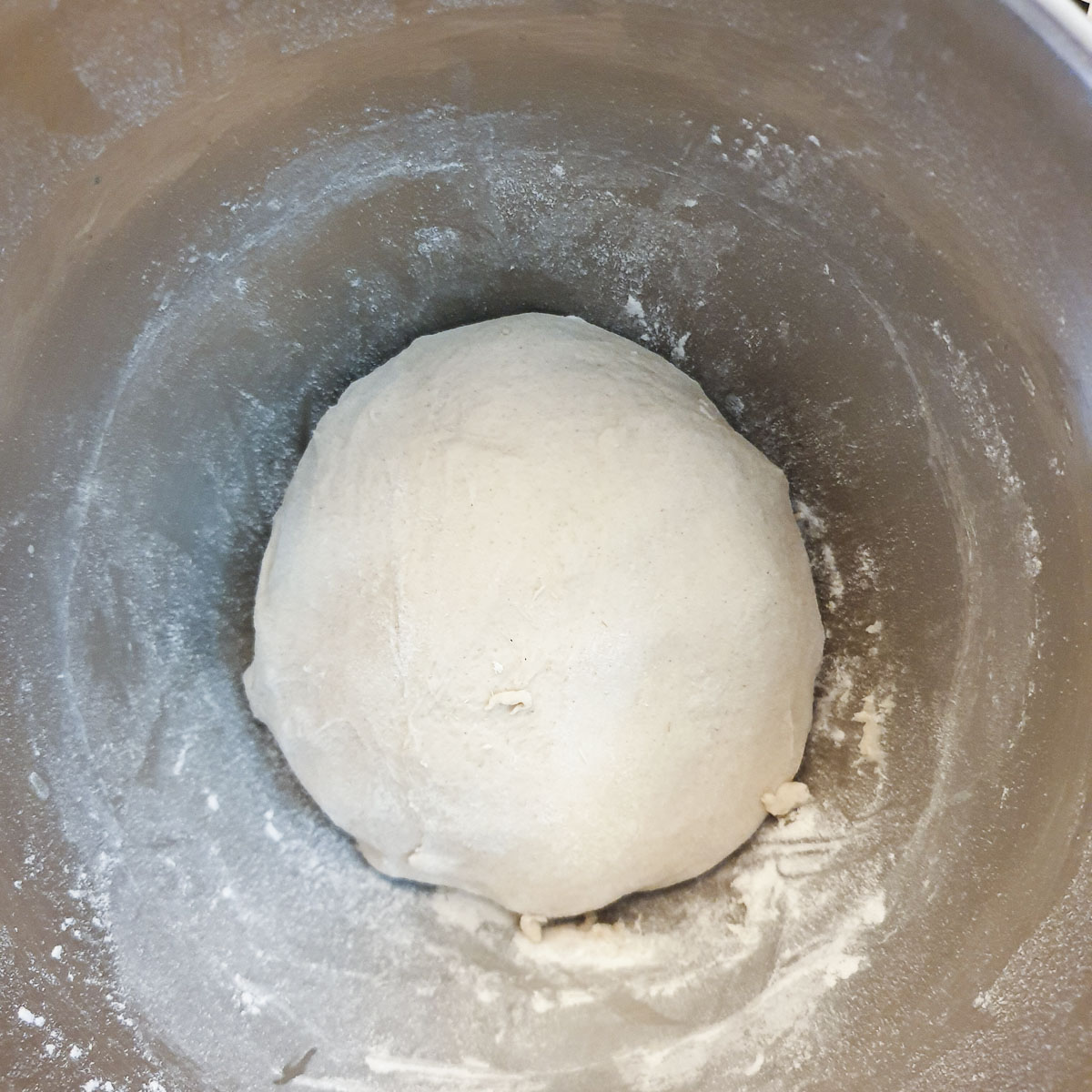 A ball of unrisen dough in a bowl.