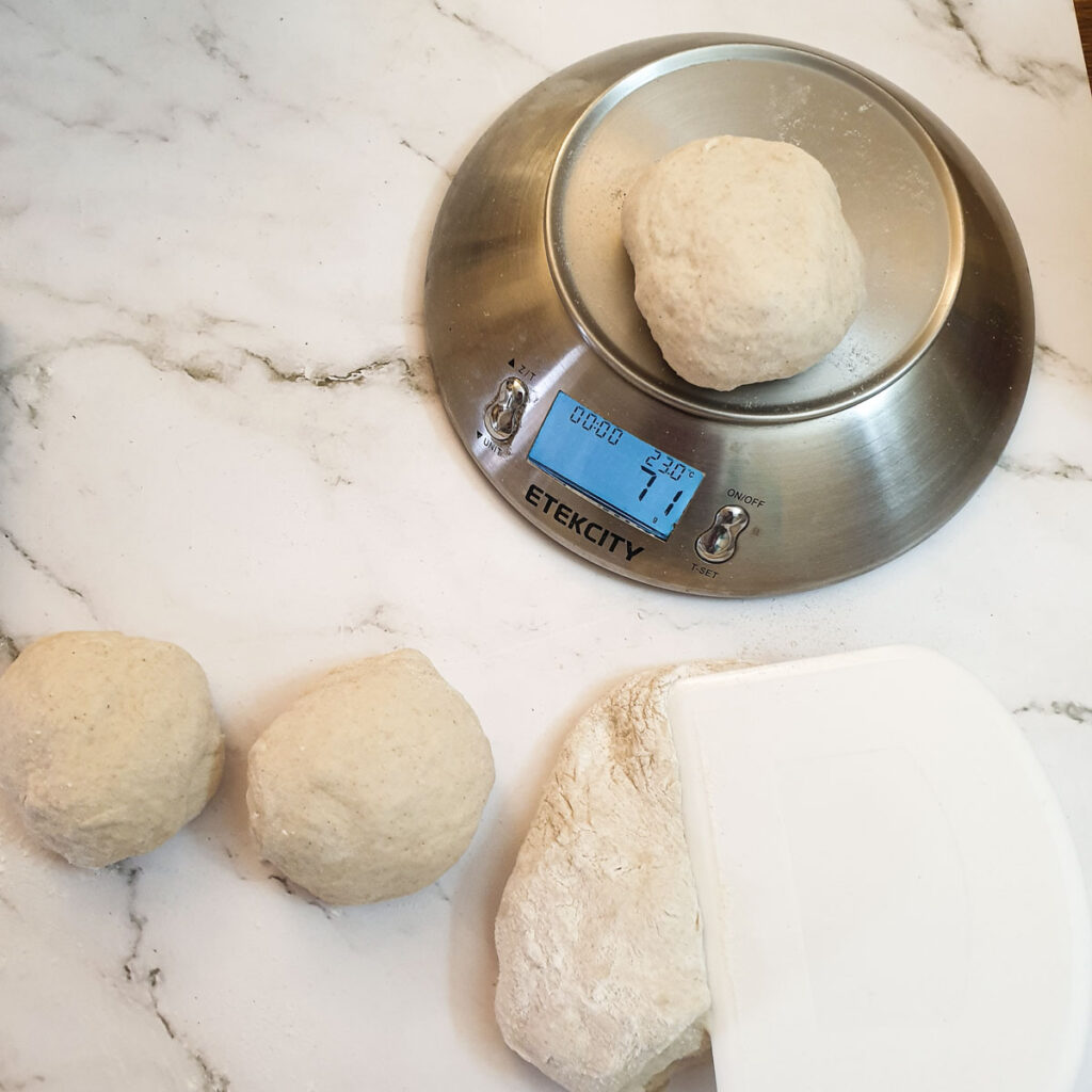 The dough being divided into 12 equal pieces.