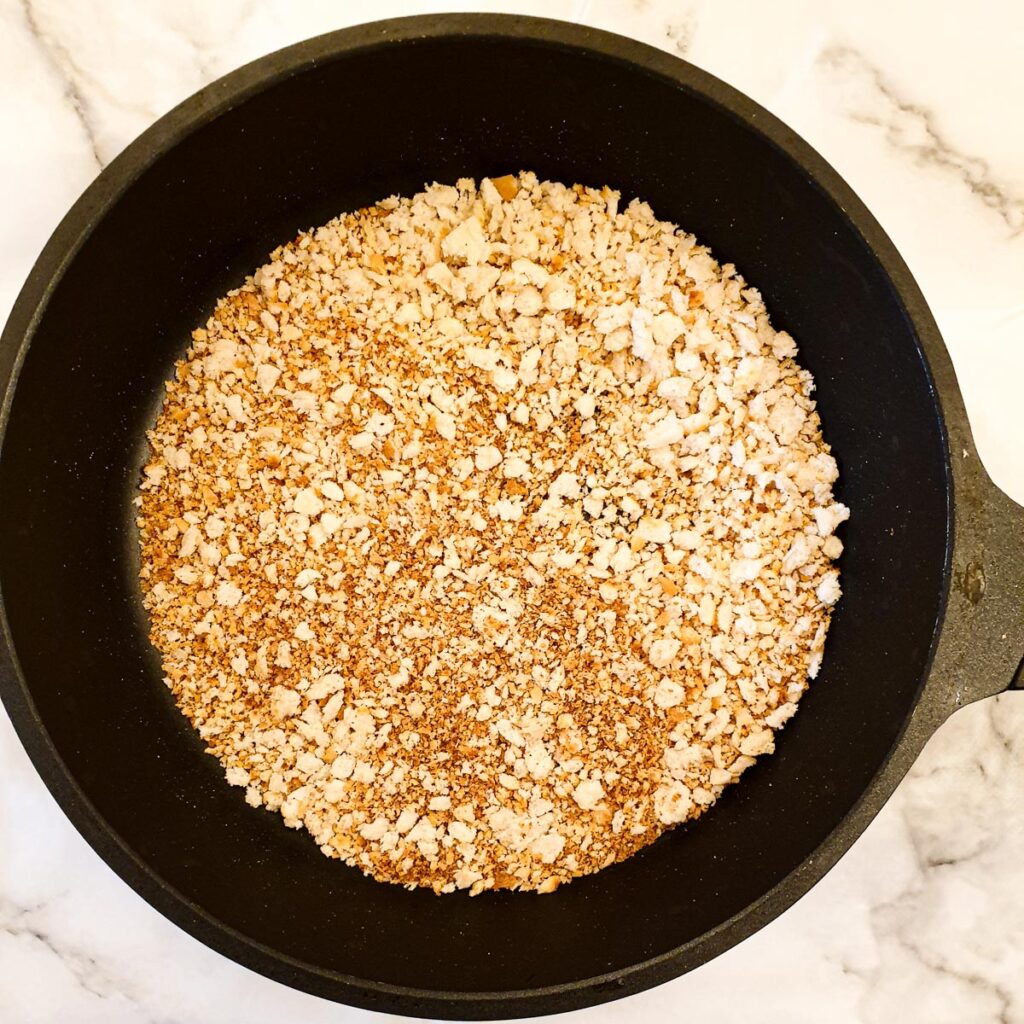 Toasted breadcrumbs in a frying pan.