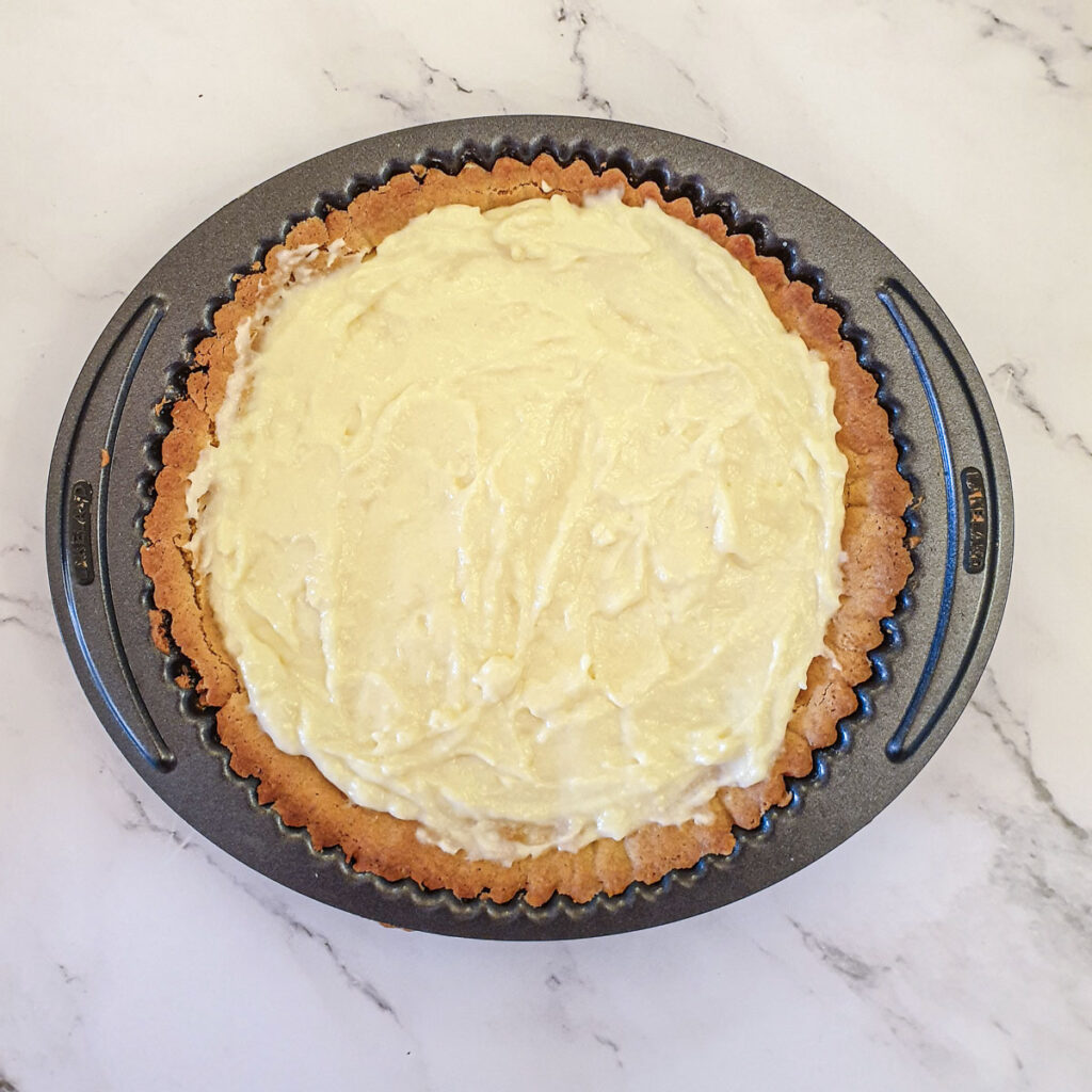 A baked pie shell filled with custard.