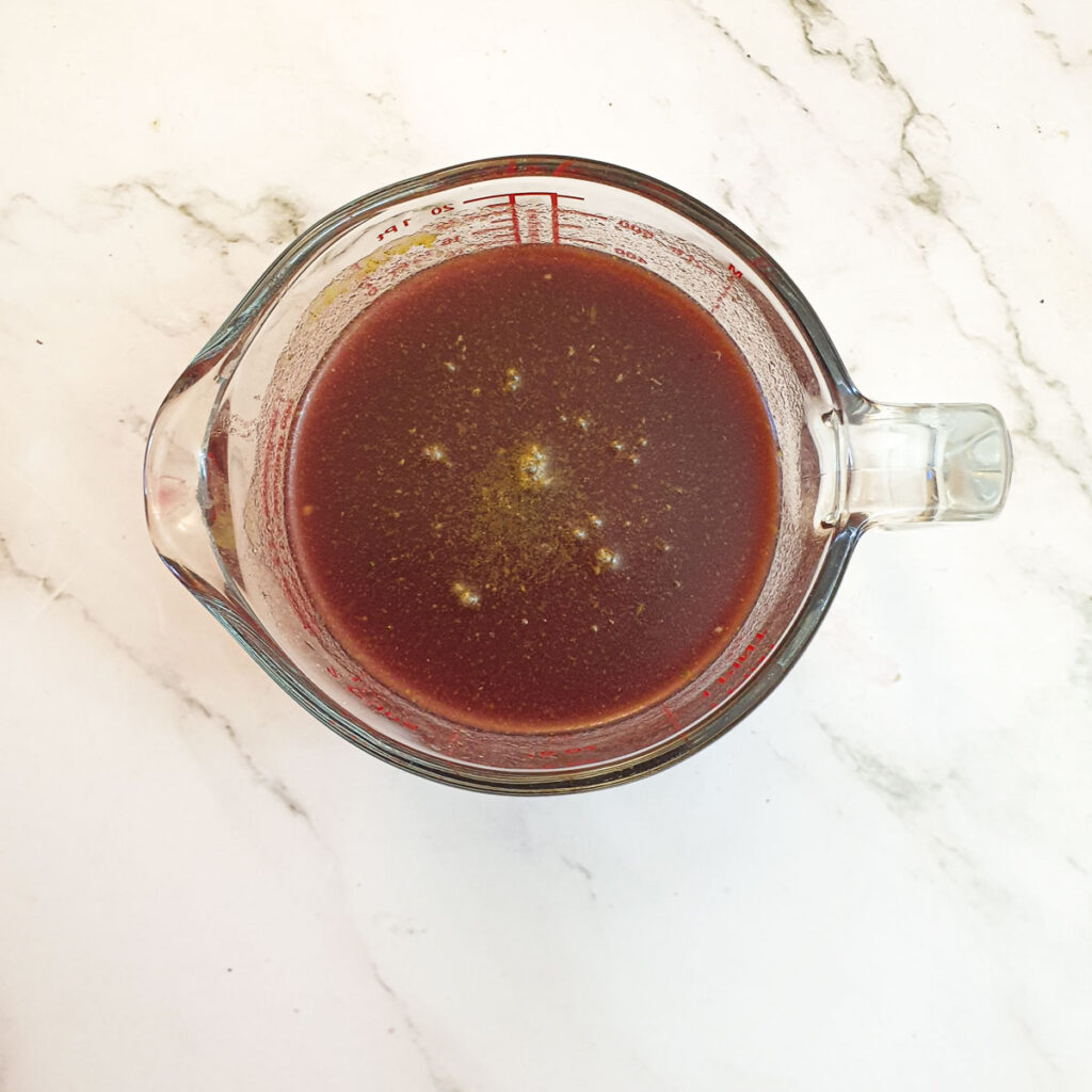 A jug of stock ready to be added to the slow-cooker.