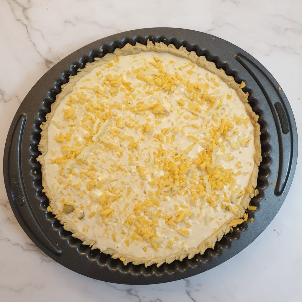 Grated cheese sprinkled on top of the custard.