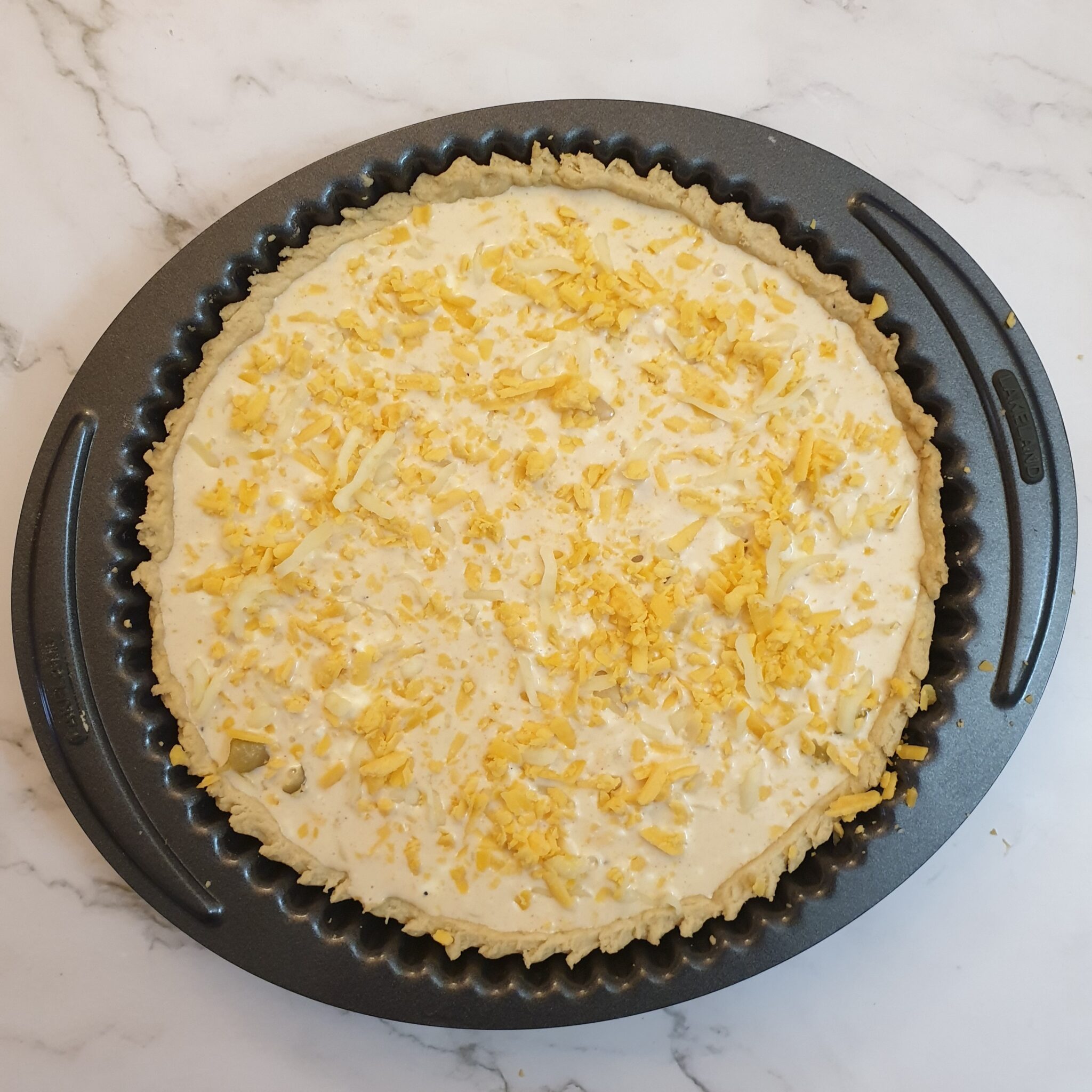 Grated cheese sprinkled on top of the custard.