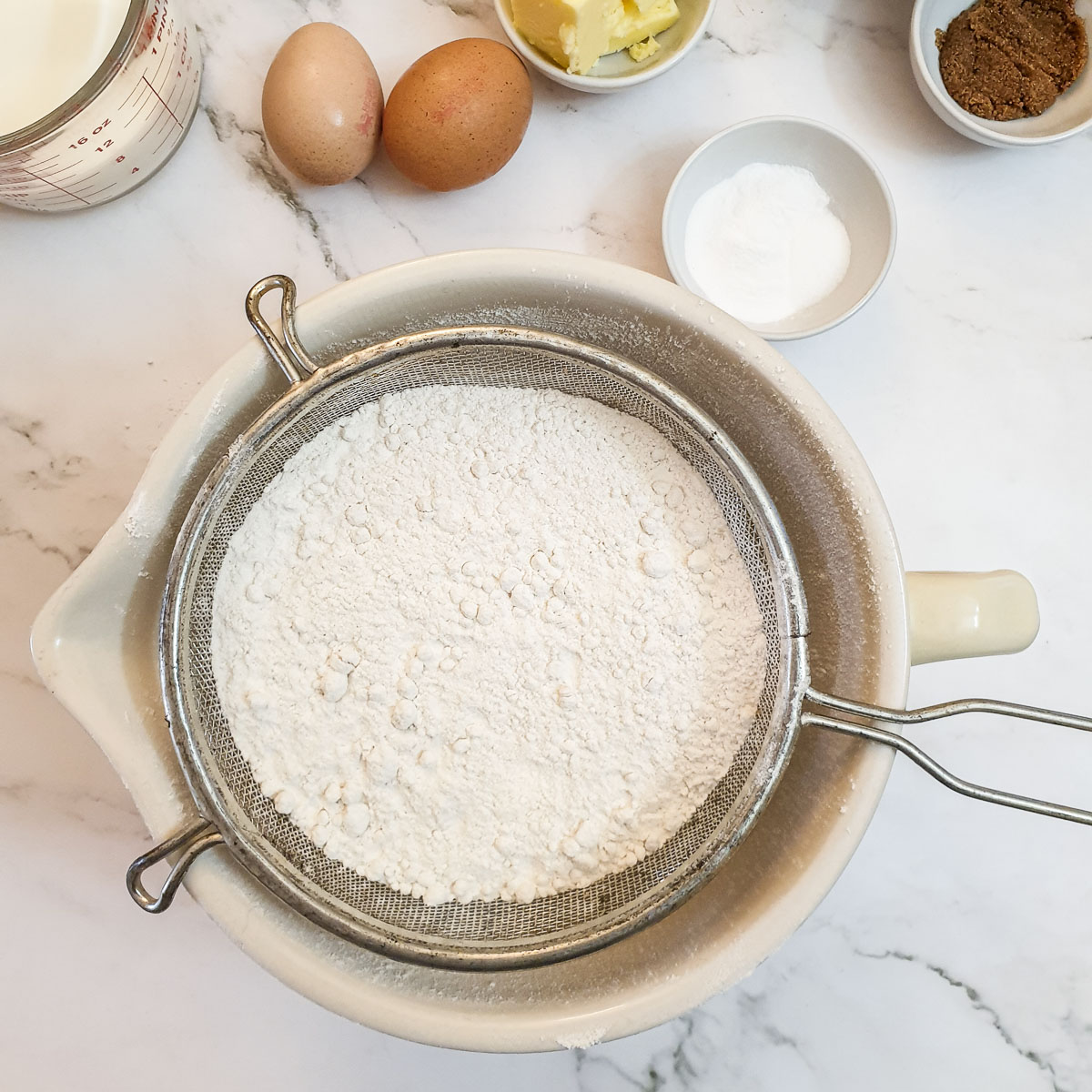 Flour being sifted into a bowl.