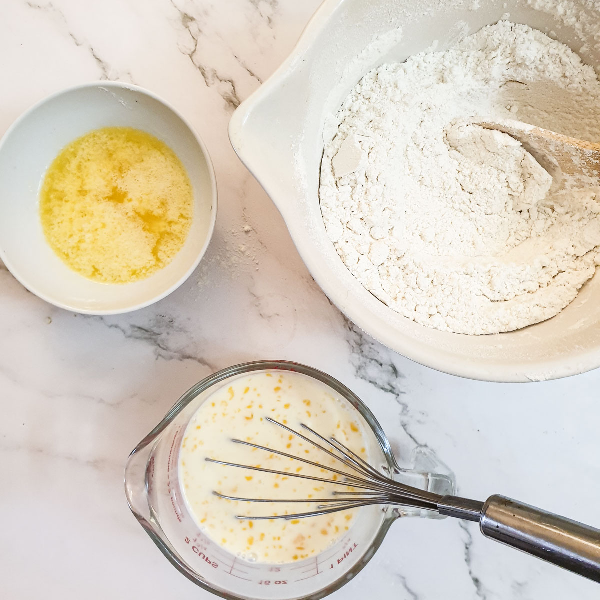 Three bowl, one with melted butter, one with flour and  third with milk and beaten egg.