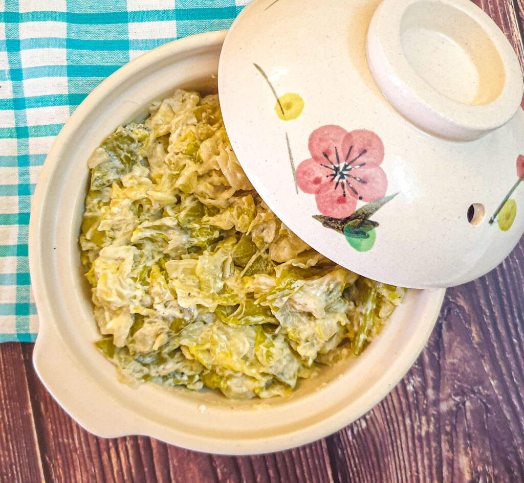 Buttery braised cabbage and sugar snap peas in a serving dish.