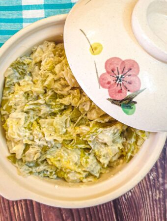 Buttery braised cabbage and sugar snap peas in a serving dish.