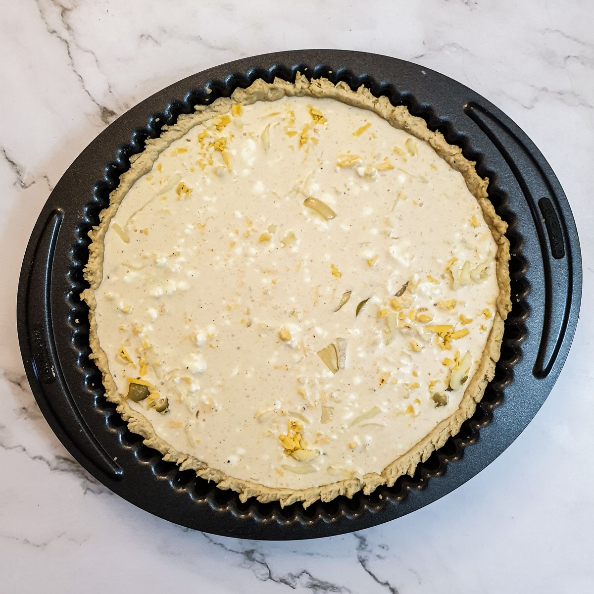 Onions and grated cheese in a pie crust, covered with a cream and egg mixture.