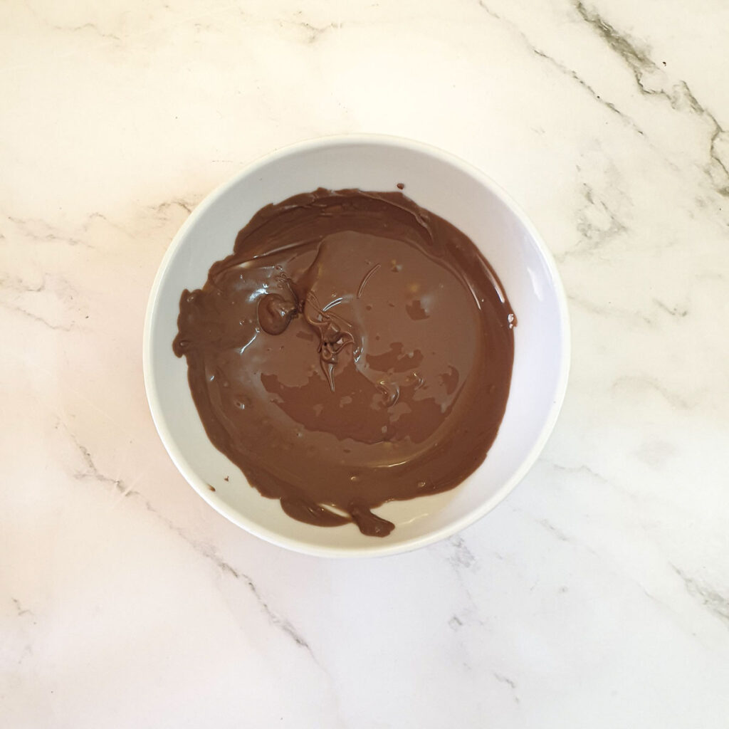 A bowl of melted chocolate.