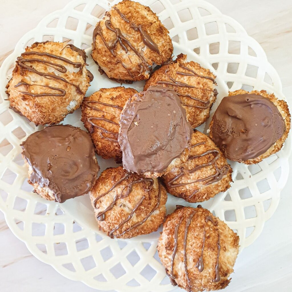 A plate of chocolate coated coconut macaroons.