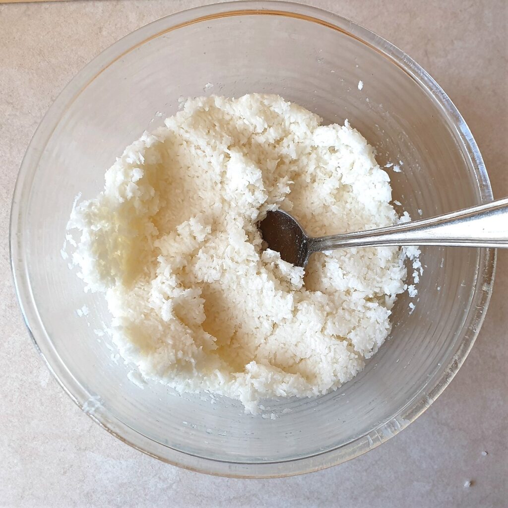 A mixing bowl containing the combined macaroon mixture.