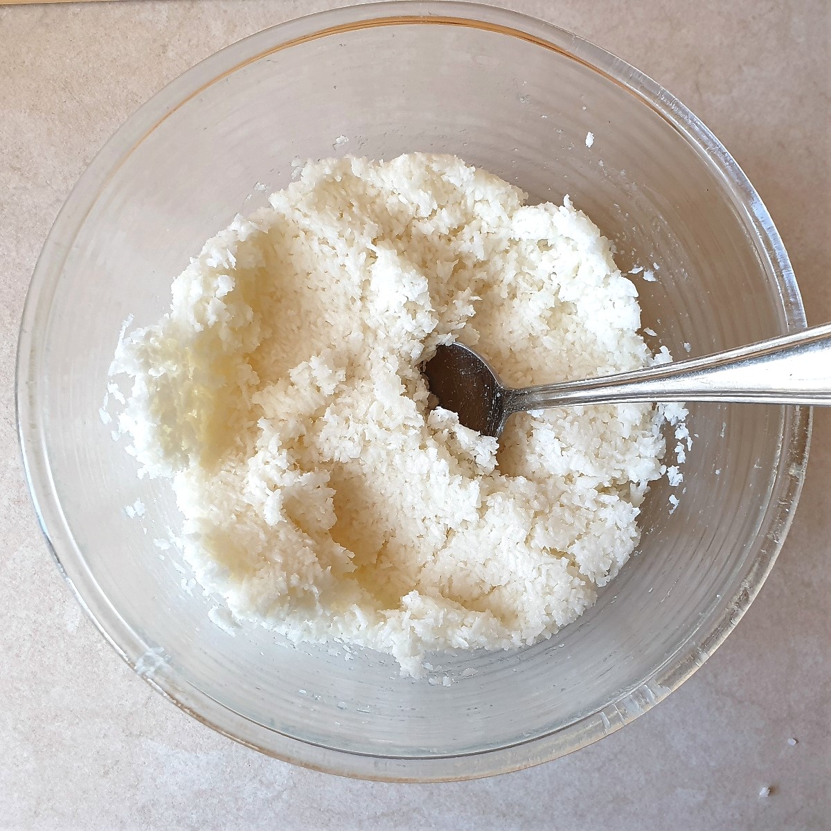 A mixing bowl containing the combined macaroon mixture.