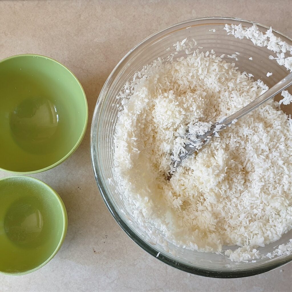 Coconut, egg whites and sugar in a mixing bowl.