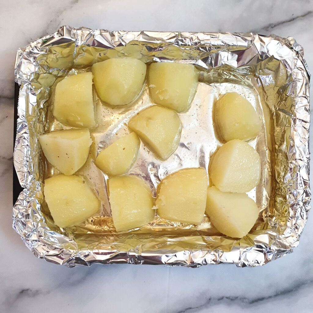Potatoes in a roasting tray.