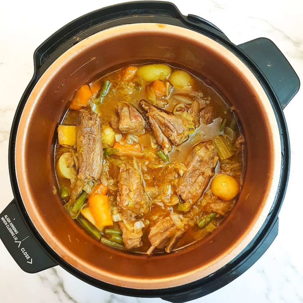 Cooked lamb stew in a pressure cooker.