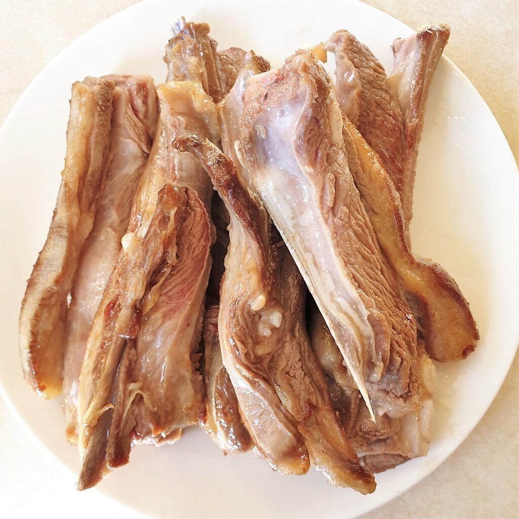 A pile of lamb ribs that have been browned.