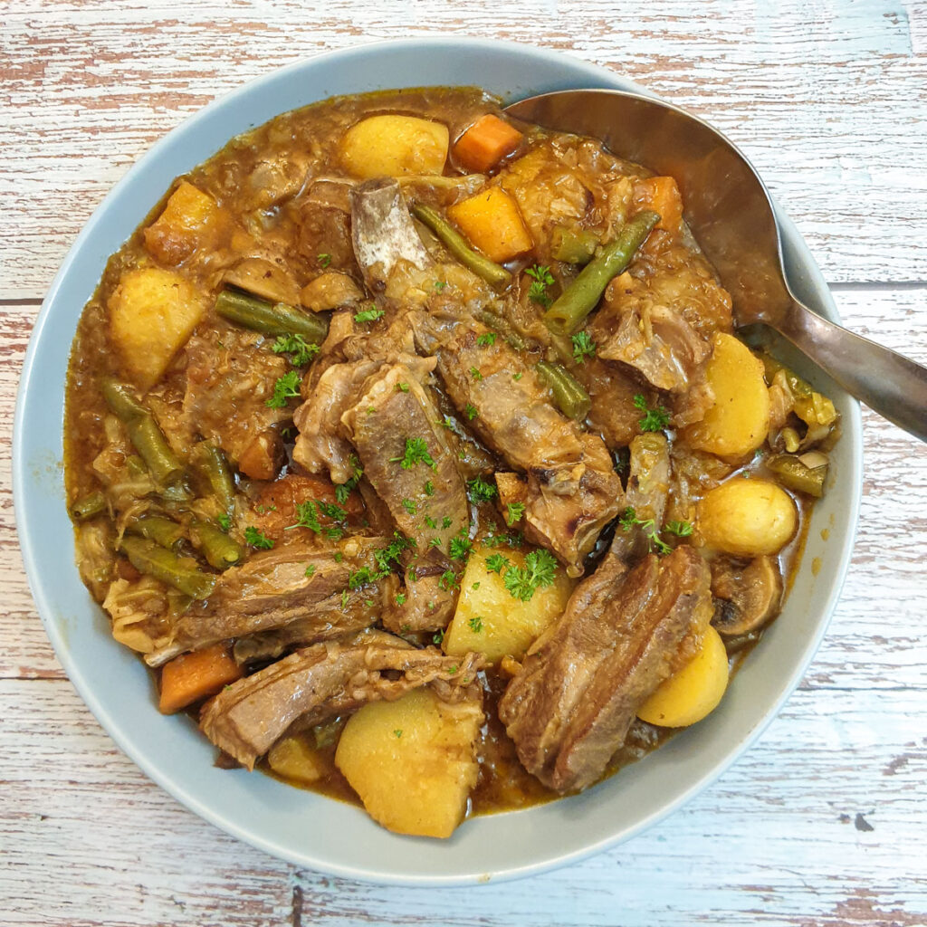 Lamb bredie (lamb stew) in  serving bowl.