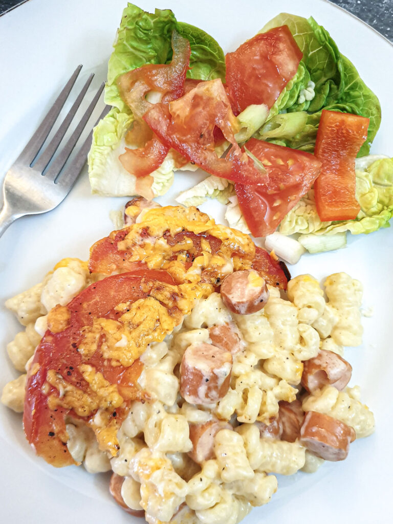 A plate of macaroni cheese deluxe with a helping of green salad.