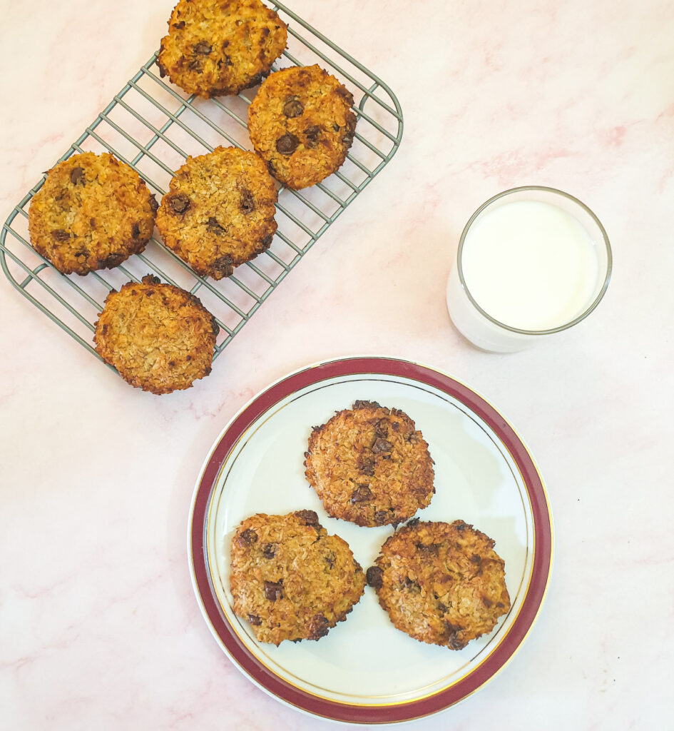 Overhead shot of banana cornflake breakfast cakes with a glass of milk.