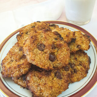 A plate of banana cornflake breakfast cakes with a glass of milk.