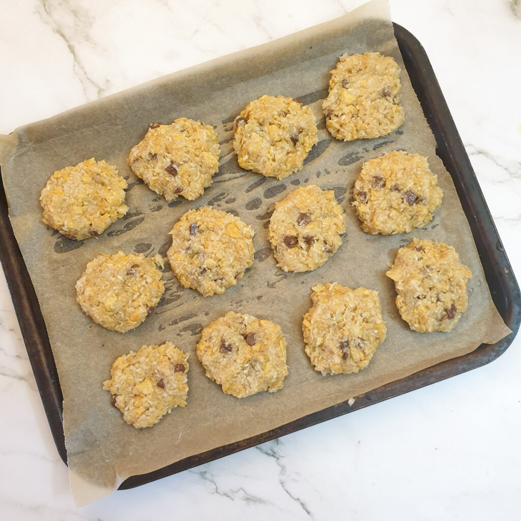 15 unbaked banana cornflake cakes on a baking tray