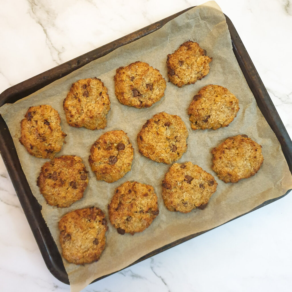 15 baked banana cornflake cakes on a baking tray