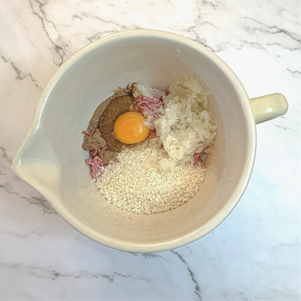 Meatball ingredients in a mixing bowl.