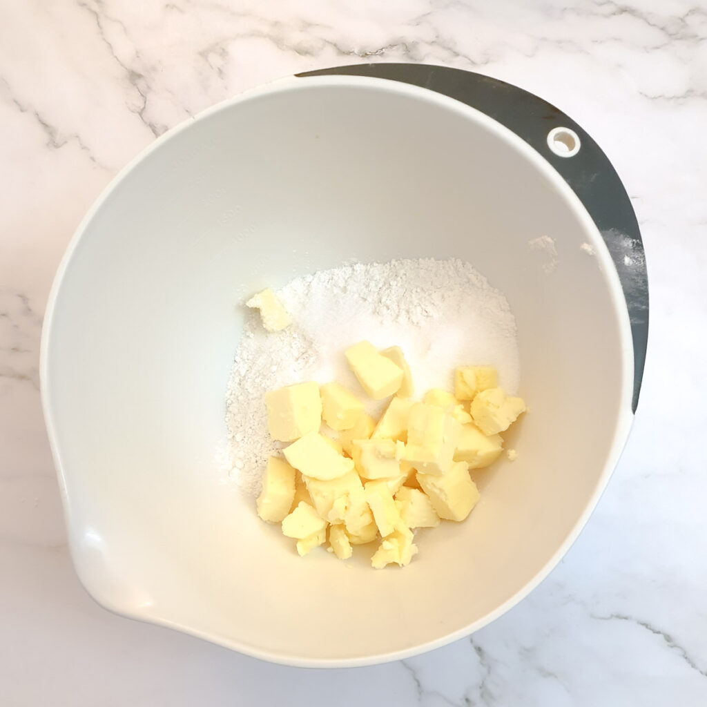 Butter and sugar in a mixing bowl.