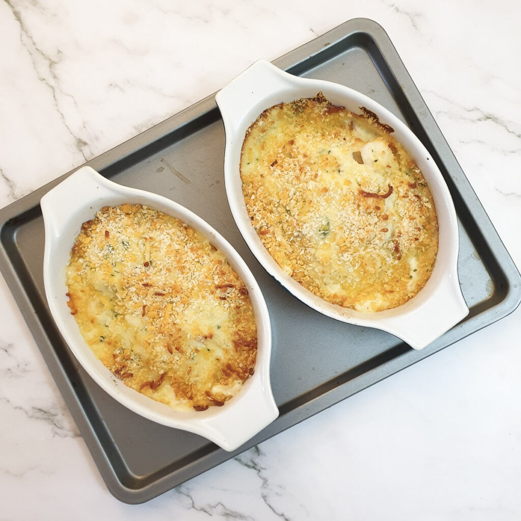 Two dishes of baked cod mornay.