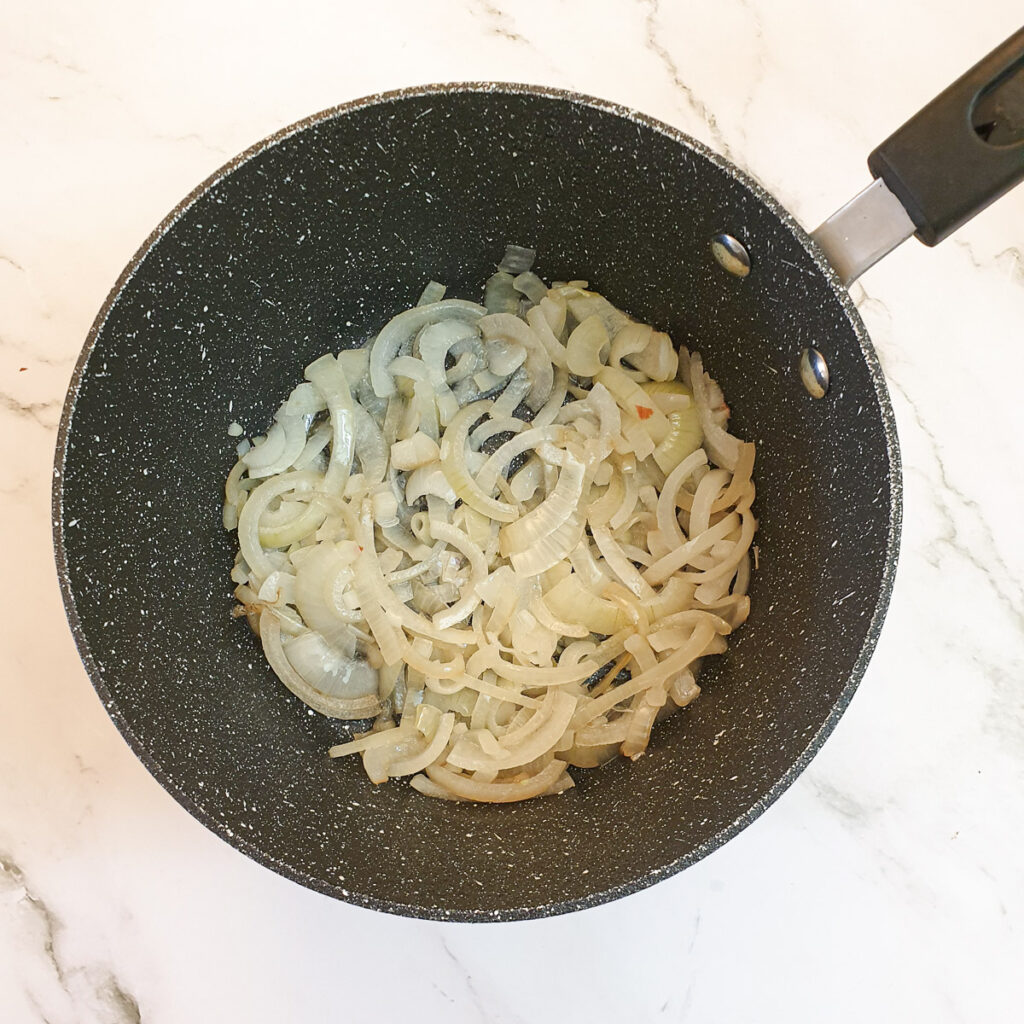 Sliced onions in a pan.