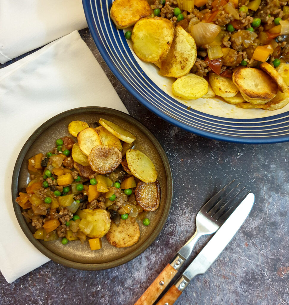 A plate of mince and sliced fried potatoes.