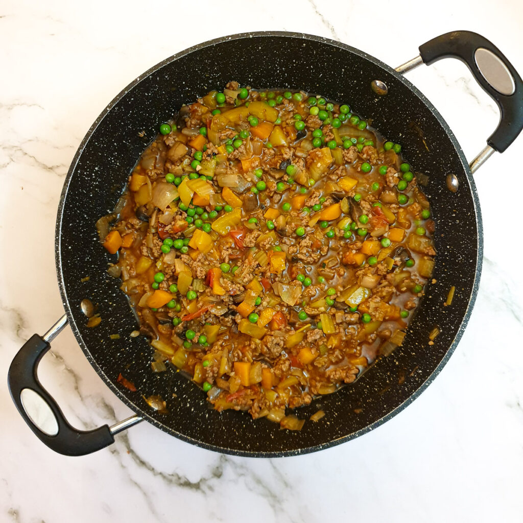 The mince and vegetables for cottage pie with the addition of peas.