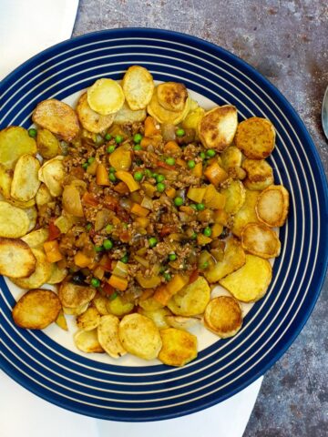 Crispy fried sliced potatoes surrounding a pile of savoury minced beef and vegetables.