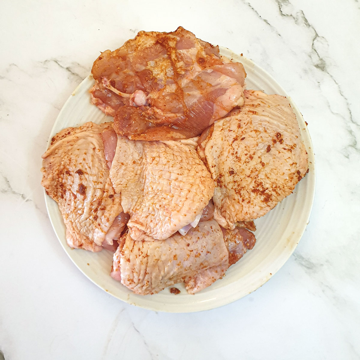 Chicken thighs coated in spices.