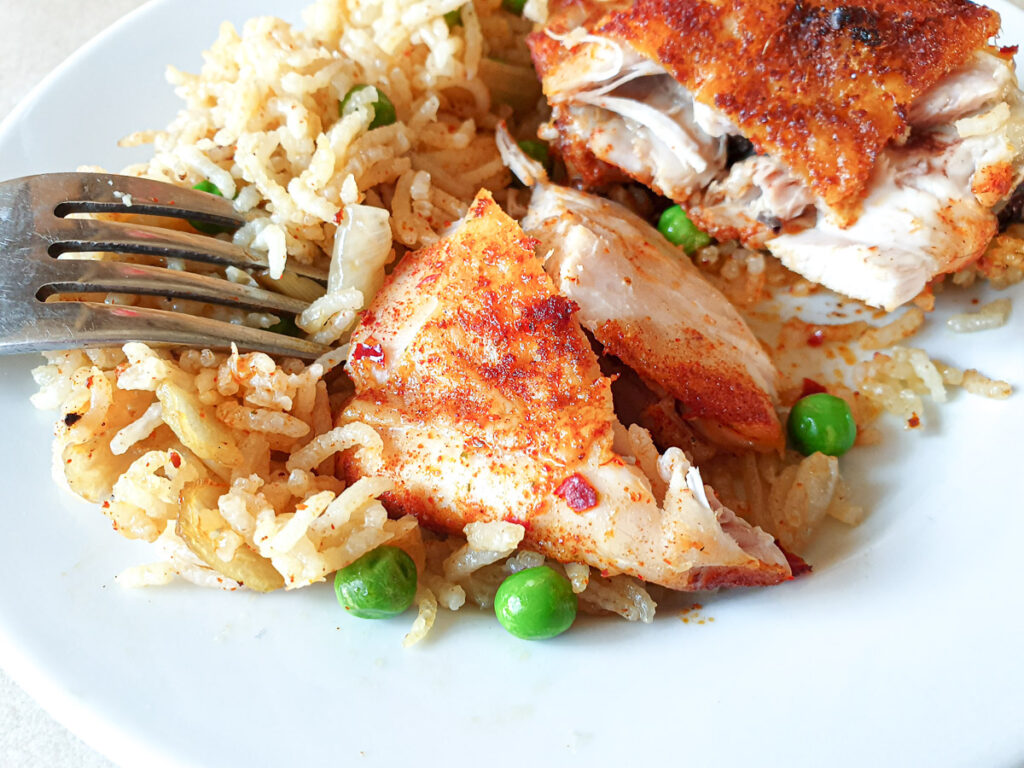 Closeup of a garlic chicken thigh.