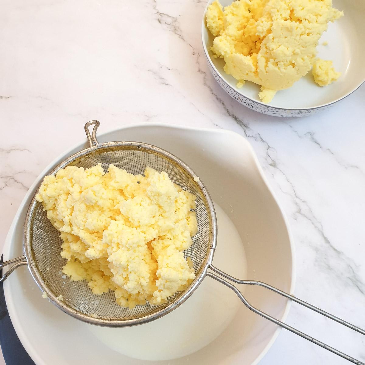 Butter in a sieve, allowing the buttermilk to drain off.
