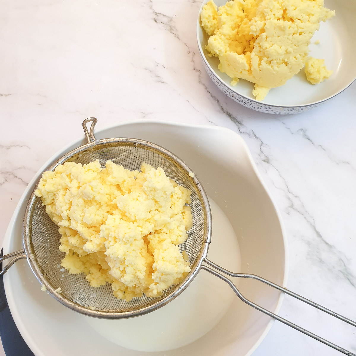 Butter in a sieve, allowing the buttermilk to drain off.