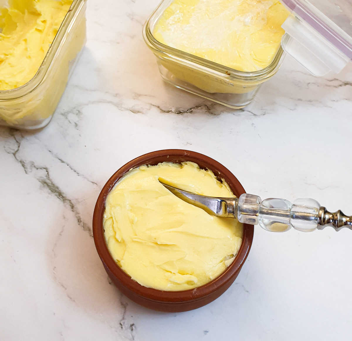 Homemade butter in a brown ramekin.